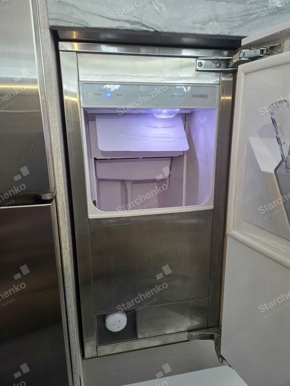 SUB-ZERO label on ice-maker control panel inside main built-in refrigerator freezer compartment.