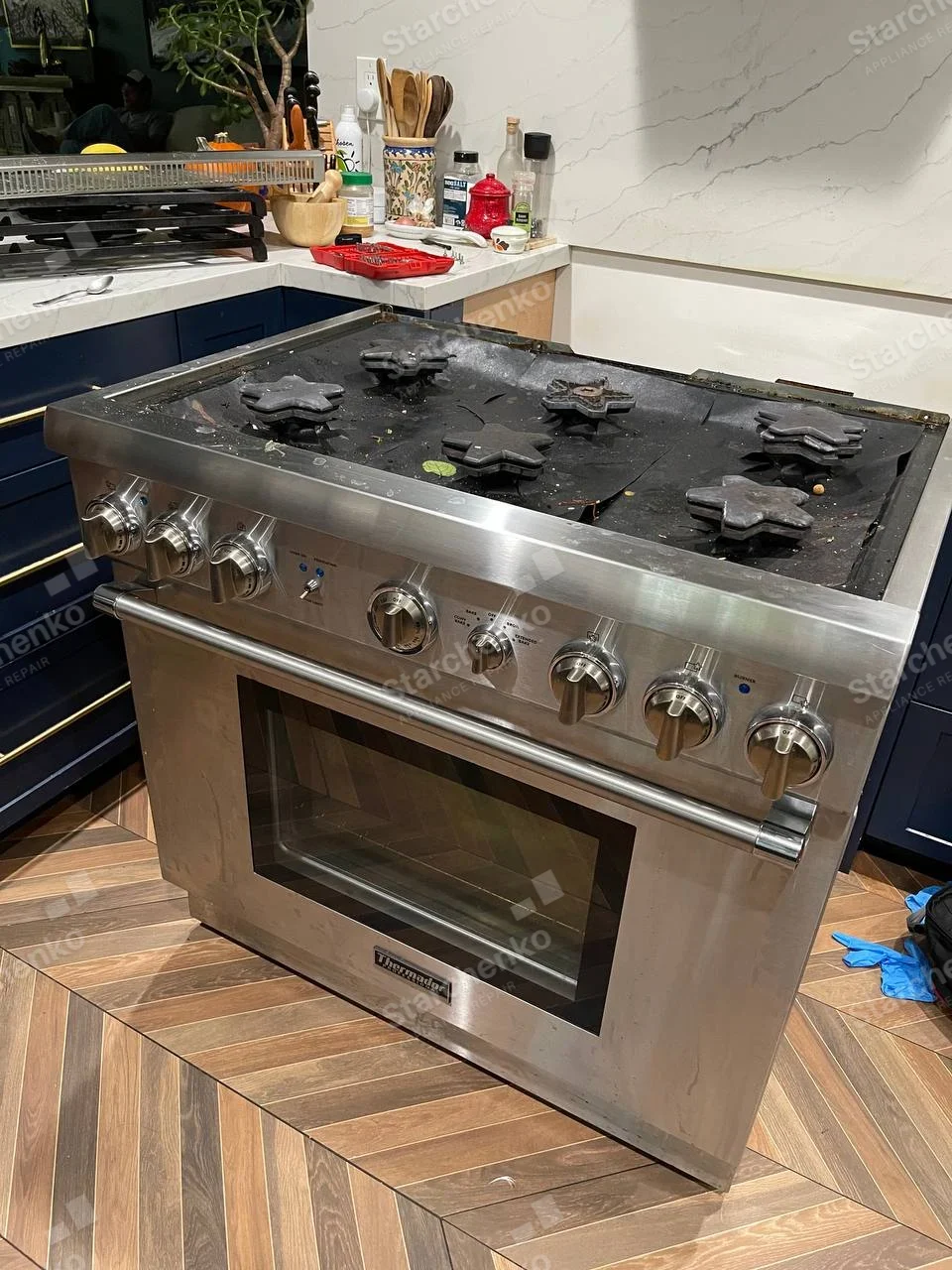 Thermador Professional gas range with exposed star-shaped burners and grates removed.