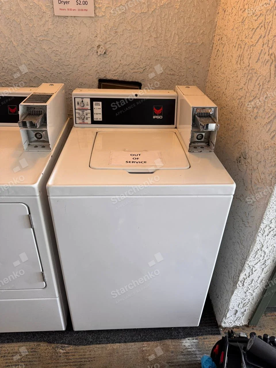 IPSO emblem on upper-right control fascia of coin-operated top-load washer, dryer-price sign on wall not appliance identity.