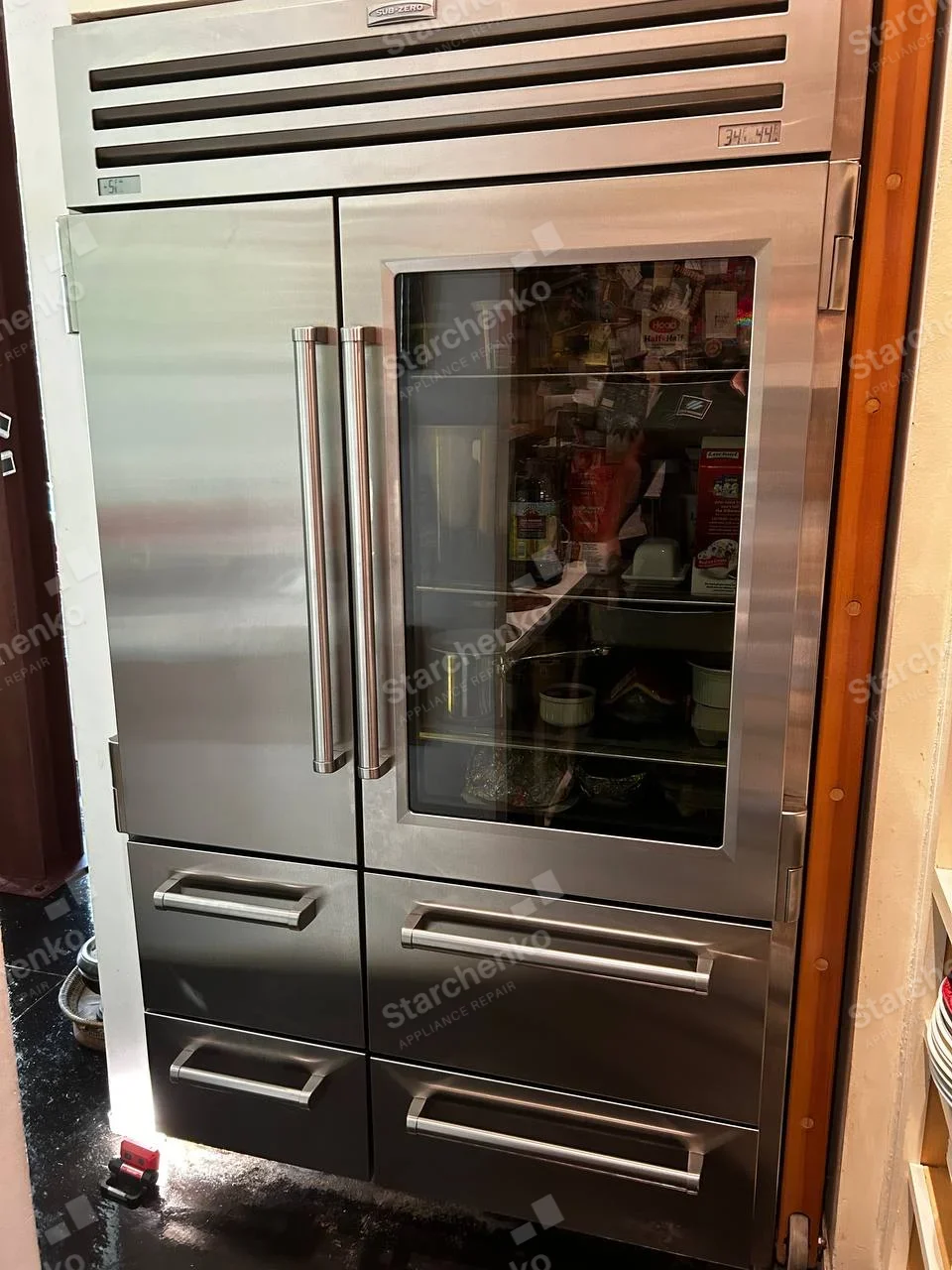 Sub-Zero repair: Large built-in French-door refrigerator with glass right door and four lower drawers.