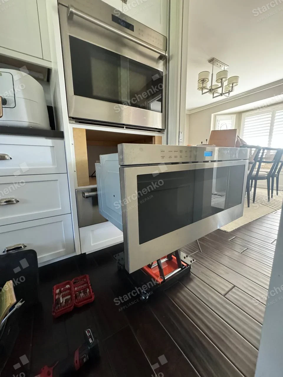 Samsung repair: Lower built-in microwave pulled from wall cavity beneath another installed oven.
