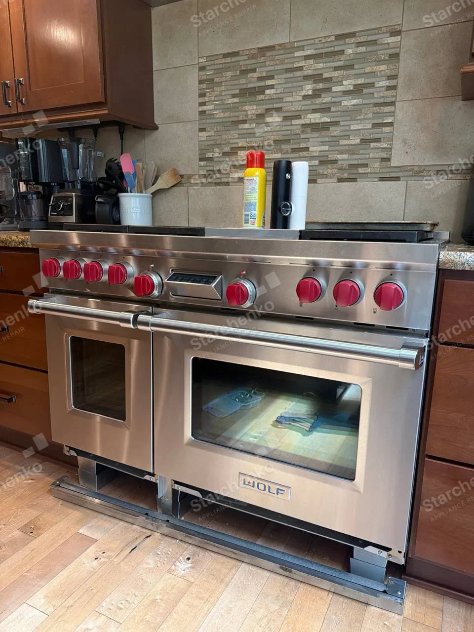 WOLF badge centered on lower front door of the large dual-oven cooking range.