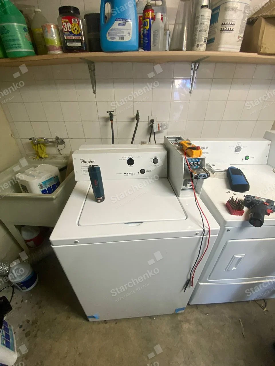 UniMac repair: Coin slide on right-hand front-load dryer with test leads.