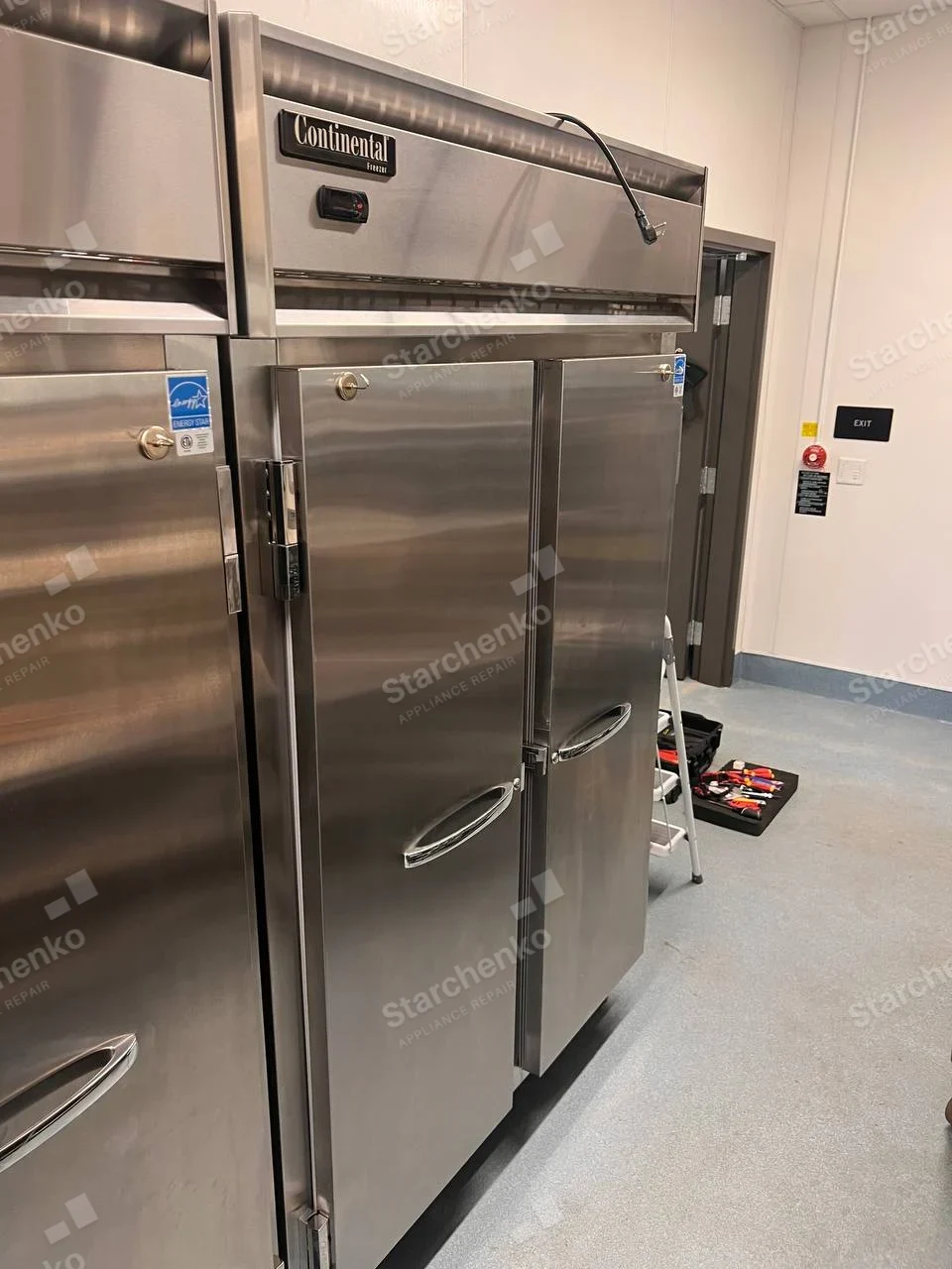 Stainless Continental two-door upright commercial freezer in kitchen service room.