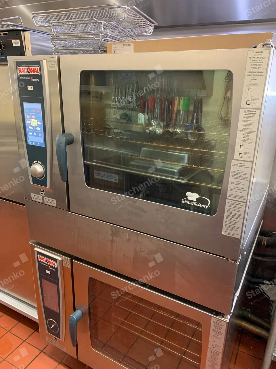 Two stacked Rational commercial combi ovens with glass doors and digital control panels.