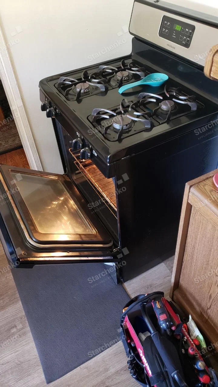 Black Frigidaire four-burner gas range with oven door open.