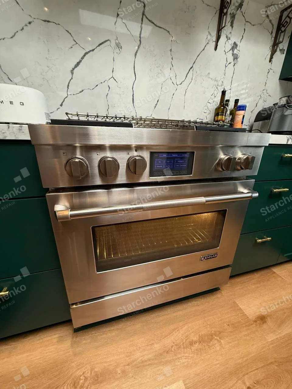 JENN-AIR badge on lower-right oven door of main gas range.