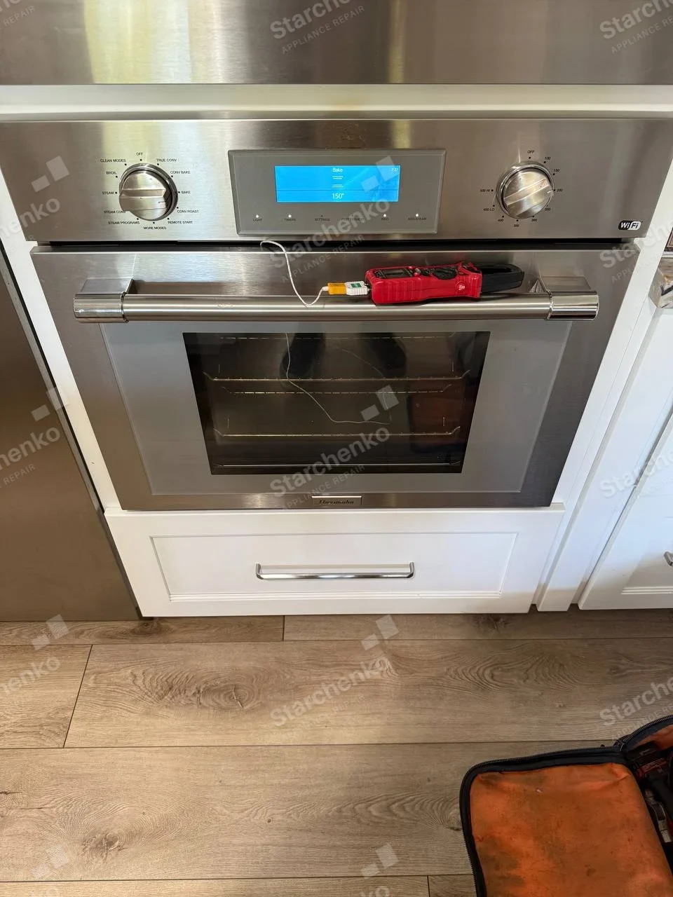Thermador badge centered beneath door of built-in oven, probe and display show heat test.