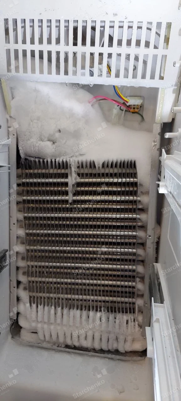 Kenmore repair: Exposed refrigerator freezer evaporator coil with heavy frost accumulation.