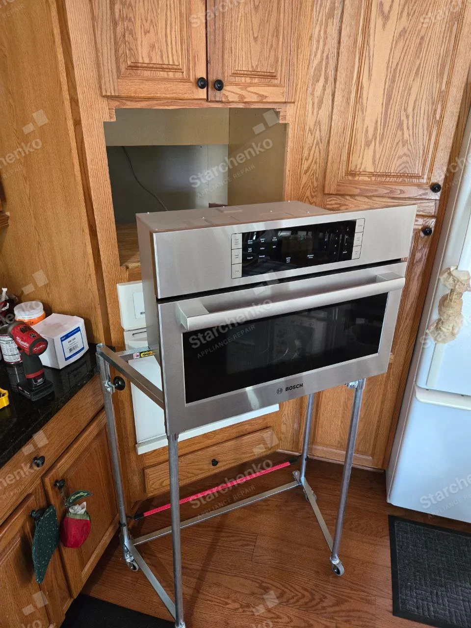 Bosch repair: Built-in microwave oven removed from cabinet and placed on wheeled service stand.