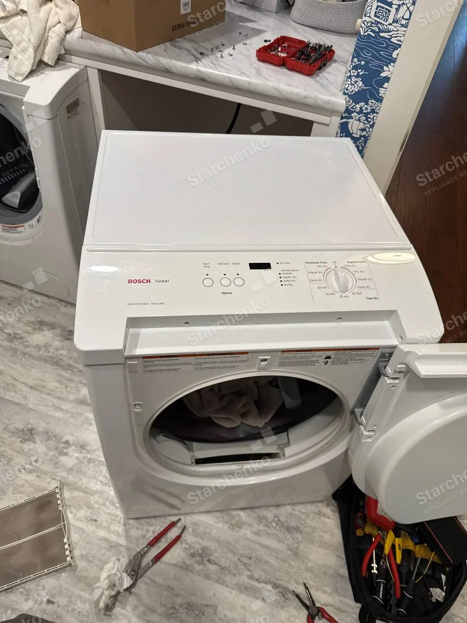 Bosch Nexxt dryer with door open and lint filter removed.