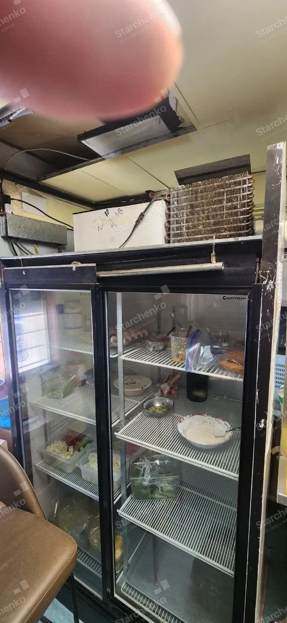 Two-door Coolstream glass commercial refrigerator with refrigeration compartment open above.
