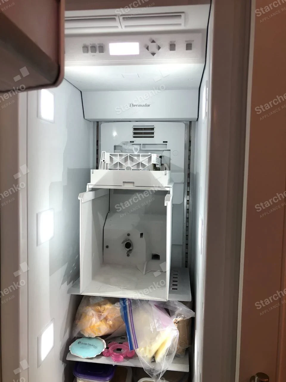 Thermador refrigerator interior with ice-maker assembly removed from freezer compartment.
