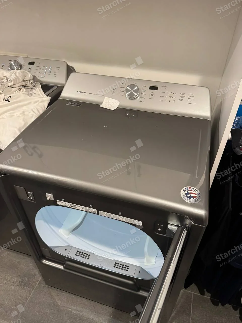 MAYTAG printed on main dryer label above open drum, Bravos XL lettering on rear control console.