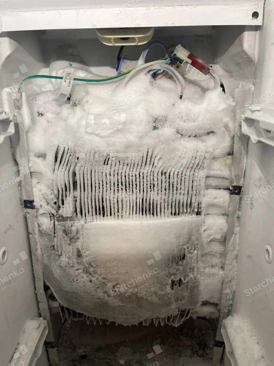 Kenmore repair: Exposed freezer evaporator fins and wires heavily covered with frost.