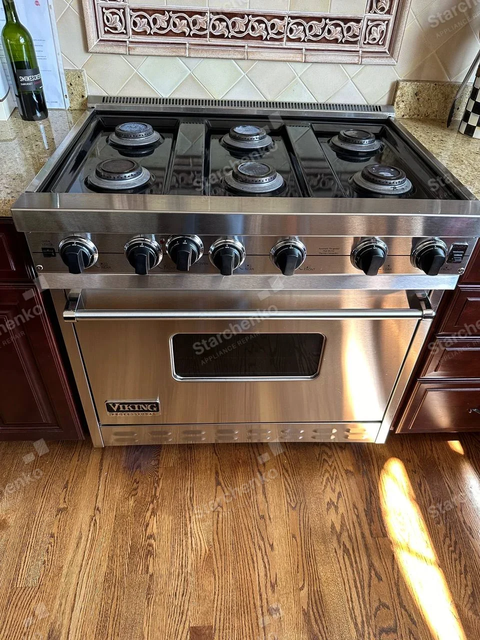 Viking repair: Six gas burners across professional-style range with oven below.