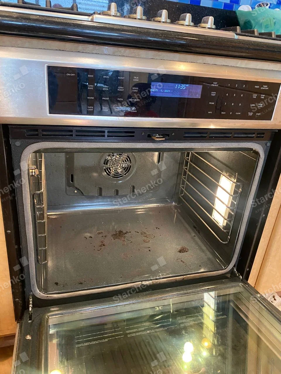 Thermador repair: Open gas range oven with convection fan, door gasket and digital control panel.