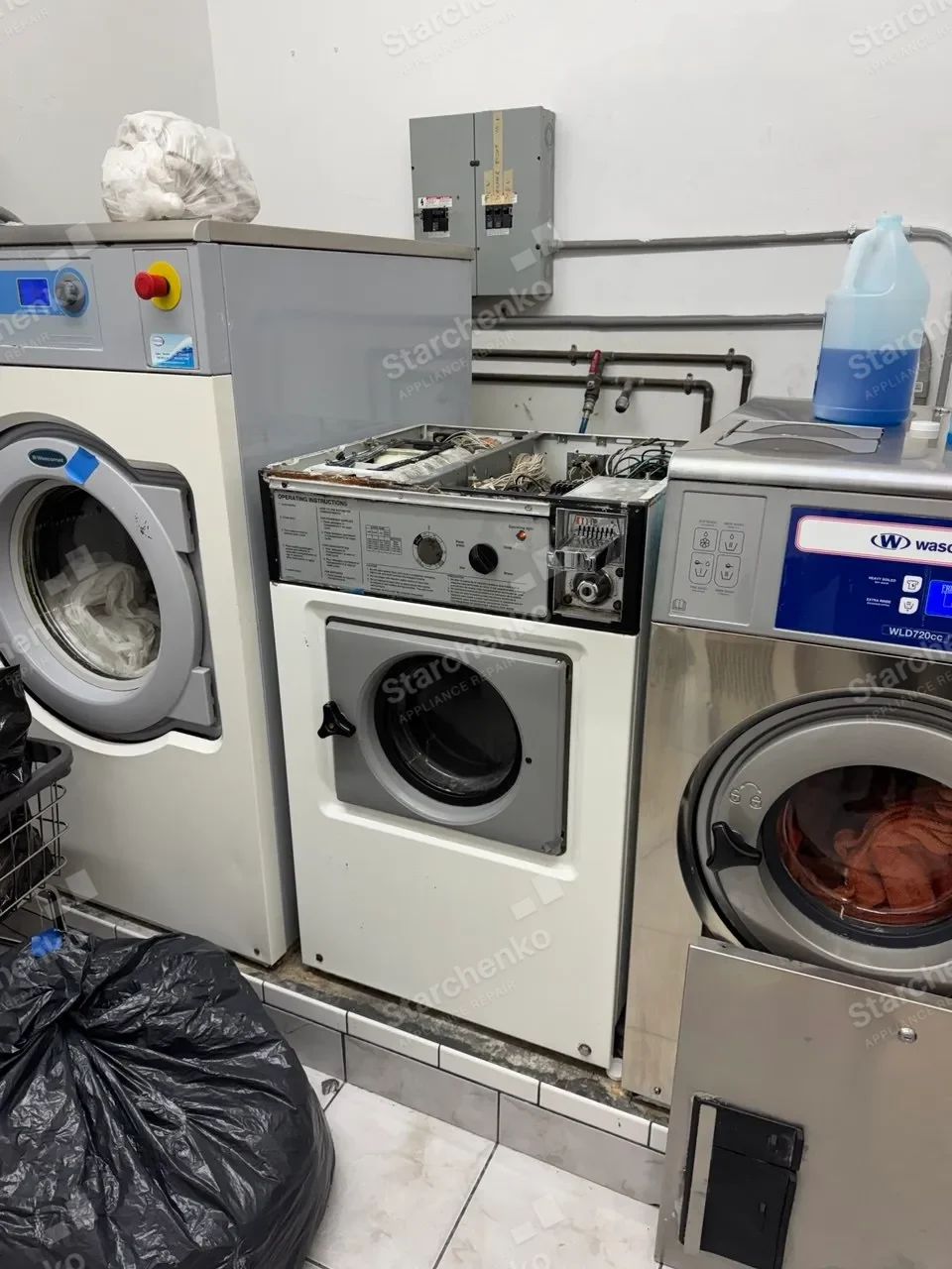 Wascomat commercial washer with the top panel removed