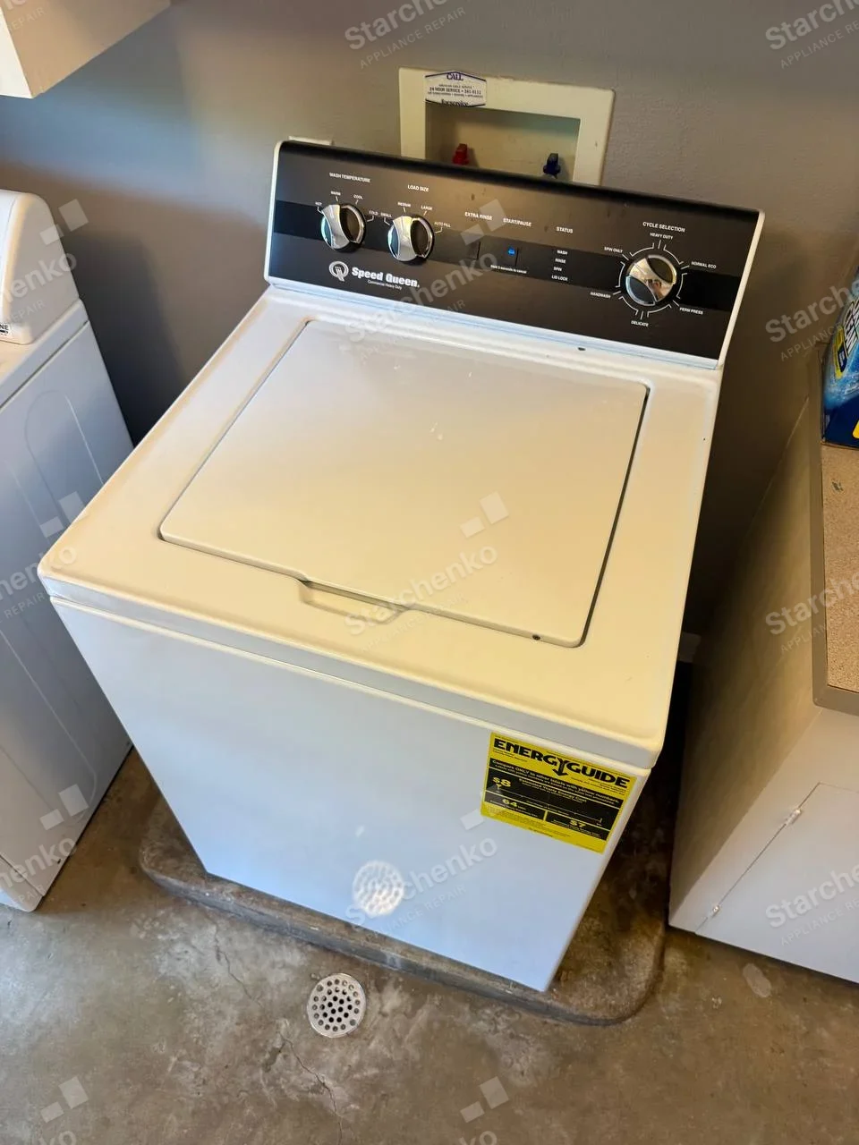 Speed Queen name on control fascia of top-load washer, cycle selector indicates wash programs.