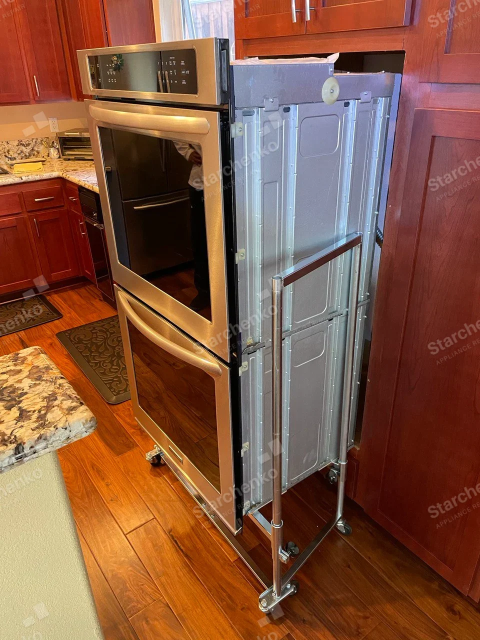 Thermador repair: Stainless double wall oven removed from cabinet on wheeled service stand.