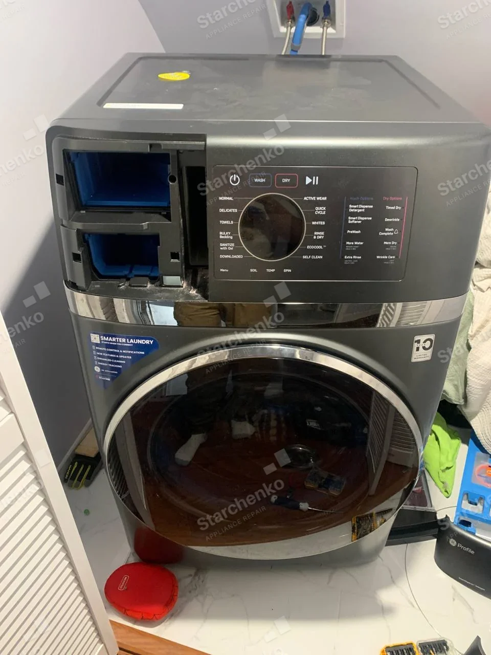 GE Profile all-in-one washer-dryer with the detergent dispenser drawers pulled out of the control panel