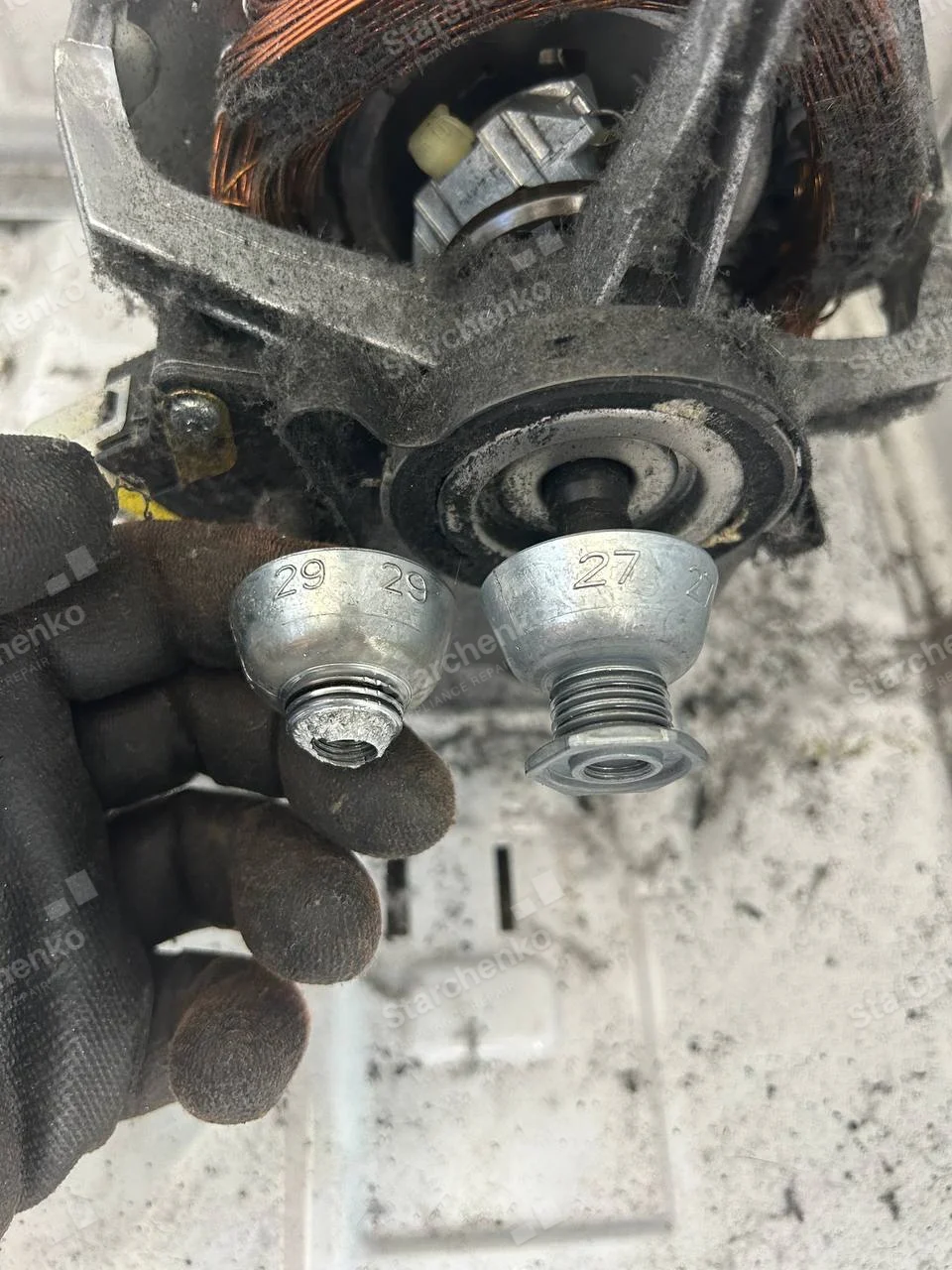 Worn dryer drive motor pulley held next to the replacement pulley on the motor shaft